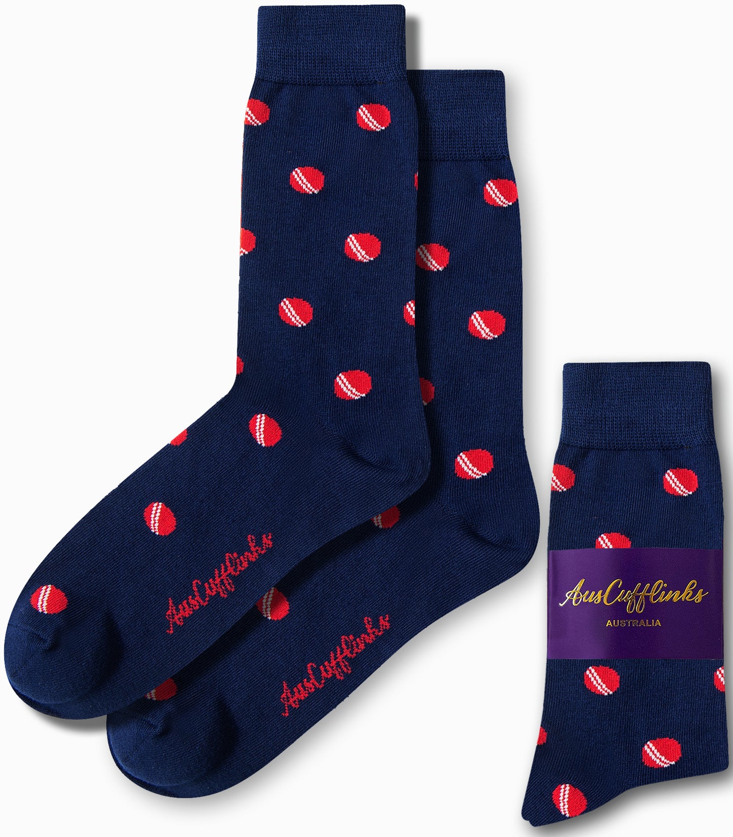 The Cricket Socks are a pair of sporty navy blue socks adorned with a pattern of small red and white cricket balls. They come with their packaging label, making them ideal for any occasion.