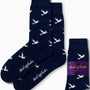 Dove Socks in navy blue, adorned with a pattern of white flying ducks, promise serene strides with every step and feature the "AusCufflinks" branding.