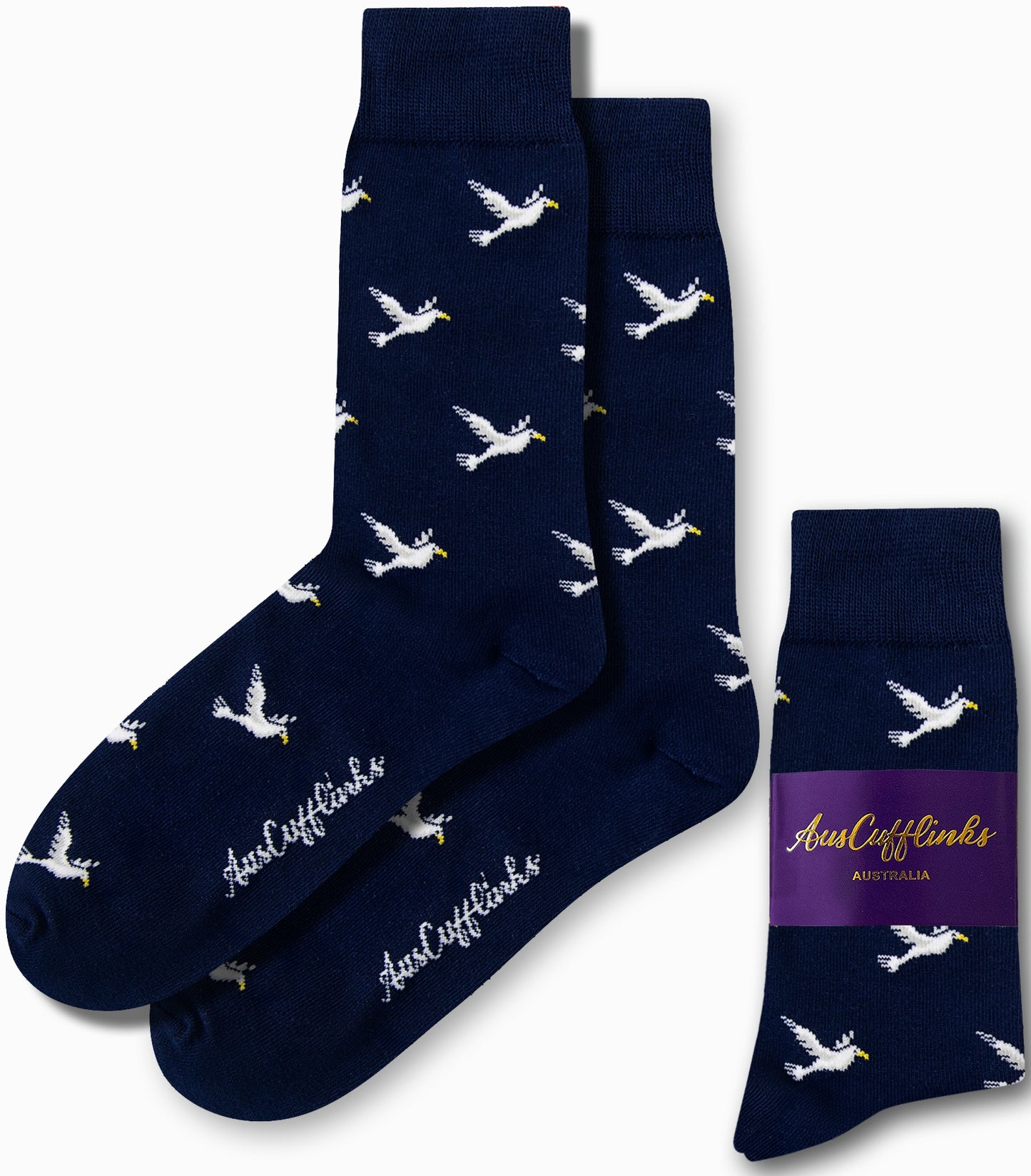 Dove Socks in navy blue, adorned with a pattern of white flying ducks, promise serene strides with every step and feature the "AusCufflinks" branding.