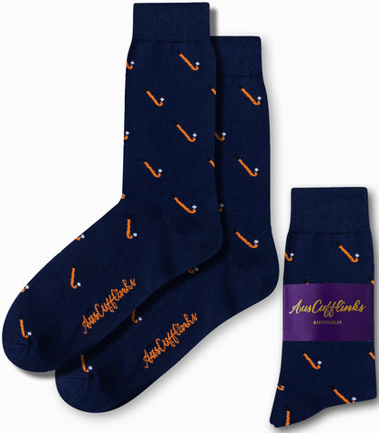 Field Hockey Socks in navy blue with an orange golf club pattern and the 'AusCufflinks' text provide both style and comfort. The pair on the right is packaged with a purple label, guaranteeing you high fashion scores.