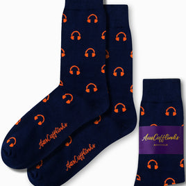 Introducing the Headphones Socks: navy blue socks adorned with an orange headphone pattern that blend style and comfort effortlessly. Showcasing the "AUS Cufflinks Australia" branding on both the side and packaging, these socks strike a perfect chord in your wardrobe ensemble.