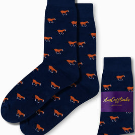 Navy blue socks featuring orange and white horse patterns, embodying a sense of hoofed elegance, are presented by "AusCufflinks Australia." These "Horse Socks" come with one pair displayed and another folded, poised to introduce a spirited gallop to your day.