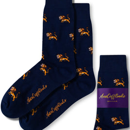 These stylish Lion Socks, featuring navy blue fabric with orange lion embroidery, are displayed as a pair and neatly folded. They come with a purple label bearing the "AusCufflinks Australia" branding, perfect for adding a touch of majesty to your wardrobe.