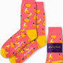 Banana Pink Socks, featuring a playful pattern of bananas in tropical hues with yellow heels and toes, displayed alongside their packaging.