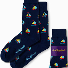 Experience the comfort of AusCufflinks craftsmanship with our Sail Boat Socks, featuring navy blue fabric embellished with a small, colorful sailboat pattern gliding along subtle wave designs.