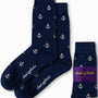 The Anchor Socks by AusCufflinks, featuring navy blue with white anchor patterns, exude nautical charm as they are elegantly laid out next to their packaging.