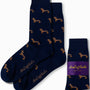 Navy Sausage Dog Socks, featuring an endearing dachshund pattern, neatly folded next to a labeled package.