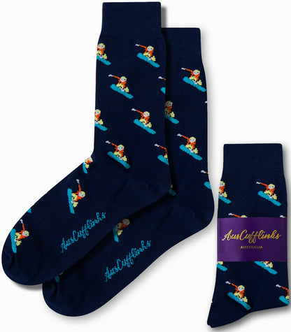 Navy blue socks showcasing a repeating pattern of snowboarders, with the brand name "AusCufflinks Australia" introducing a cool alpine style on the packaging.