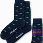 Stegosaurus Socks featuring whimsical green dinosaur patterns on a dark blue background, with "AusCufflinks" elegantly written in white script.