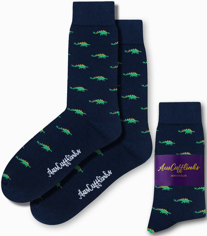 Stegosaurus Socks featuring whimsical green dinosaur patterns on a dark blue background, with "AusCufflinks" elegantly written in white script.