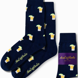 The Tequila Socks showcase a lively navy blue design adorned with a pattern of beer mugs and limes, packaged under the "AusCufflinks Australia" label.