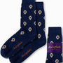 A pair of "Watch Socks" in navy blue, adorned with stylish watch patterns, prominently displays the "AusCufflinks" branding on the side. One sock is folded next to the pair, offering a timeless style that enhances your wardrobe with a touch of sophistication.