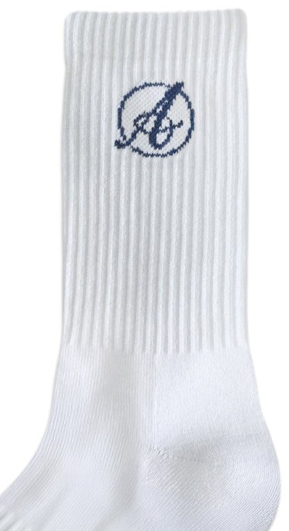 The AusCufflinks Socks are white formal dress socks made from premium cotton, featuring a ribbed texture and a dark blue embroidered encircled “b” logo near the top—ideal for formal sock enthusiasts.