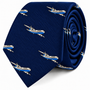 Introducing the Aeroplane Skinny Tie, featuring a rolled-up blue design adorned with a repeating pattern of white and blue commercial airplanes across the fabric.