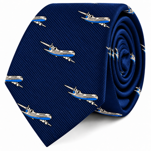 Introducing the Aeroplane Skinny Tie, featuring a rolled-up blue design adorned with a repeating pattern of white and blue commercial airplanes across the fabric.