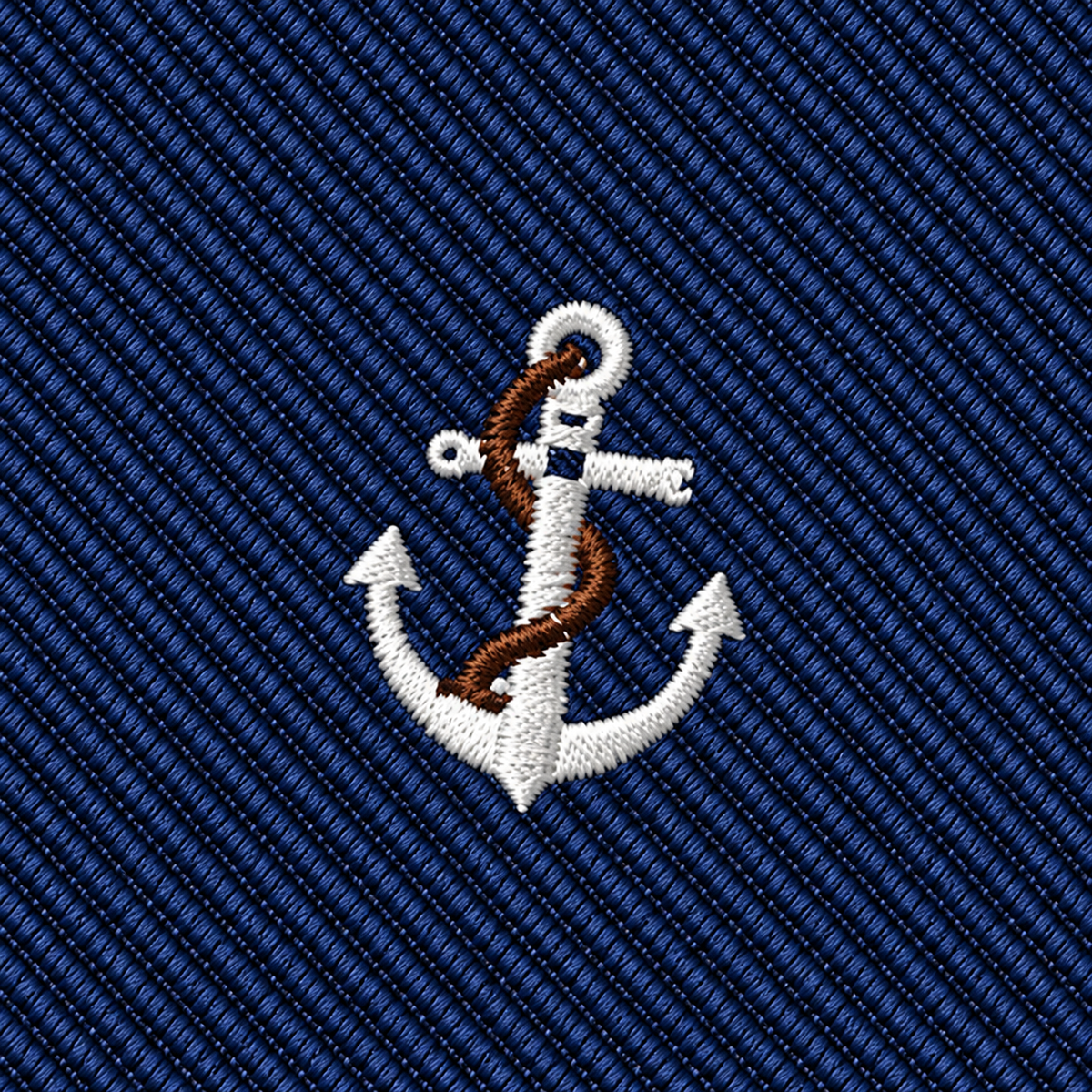 The Anchor Skinny Tie features an embroidered white anchor with a brown rope, centered on a blue fabric background with diagonal stripes, making it the ideal accessory for anyone looking for a classic nautical touch at a wedding.