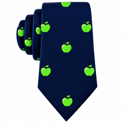 The Apple Skinny Tie is a navy blue necktie adorned with a repeating pattern of embroidered green apples—each detailed with leaves and a small bite taken out—adding a playful touch to any outfit.