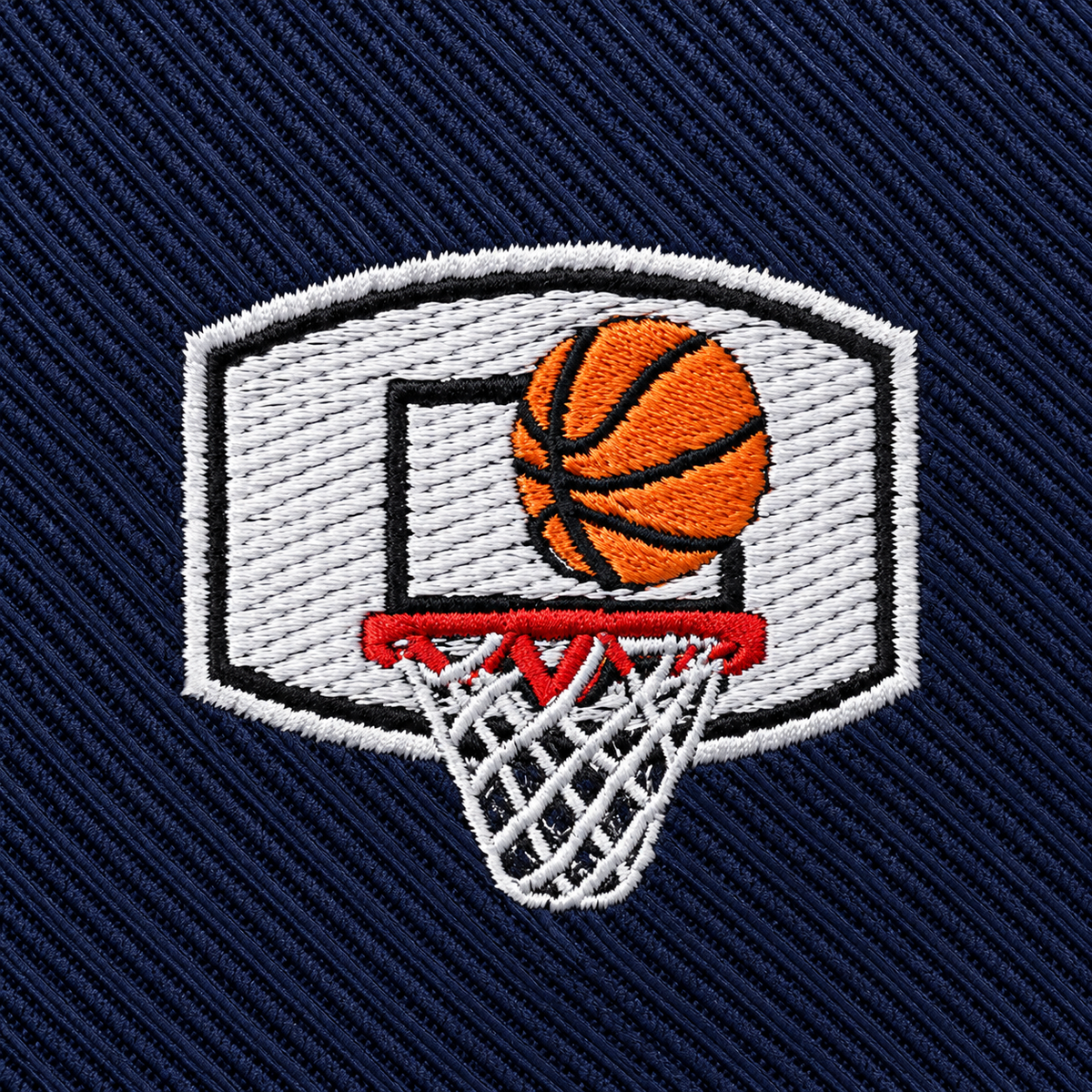 Introducing the Basketball Backboard Skinny Tie—a dark blue tie with diagonal ridges, featuring an NBA-inspired embroidered patch of a basketball going through a hoop—perfect as a unique gift for any basketball player.