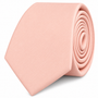 The Baby Pink Skinny Tie features a neatly rolled design and a smooth texture, displayed against a white background—making it the ideal men’s tie and perfect wedding accessory for a polished look.