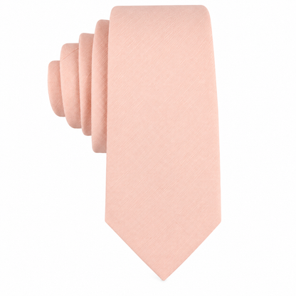 The Baby Pink Skinny Tie is displayed neatly rolled against a white background, making it an ideal men’s tie or wedding accessory.
