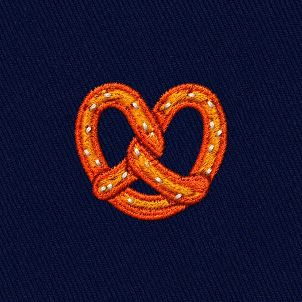 Bagel Skinny Tie featuring an embroidered bagel with salt on a dark blue fabric background—perfect for food lovers seeking a unique and playful accessory.