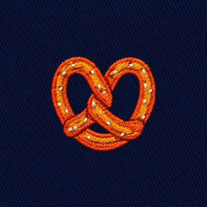 Bagel Skinny Tie featuring an embroidered bagel with salt on a dark blue fabric background—perfect for food lovers seeking a unique and playful accessory.