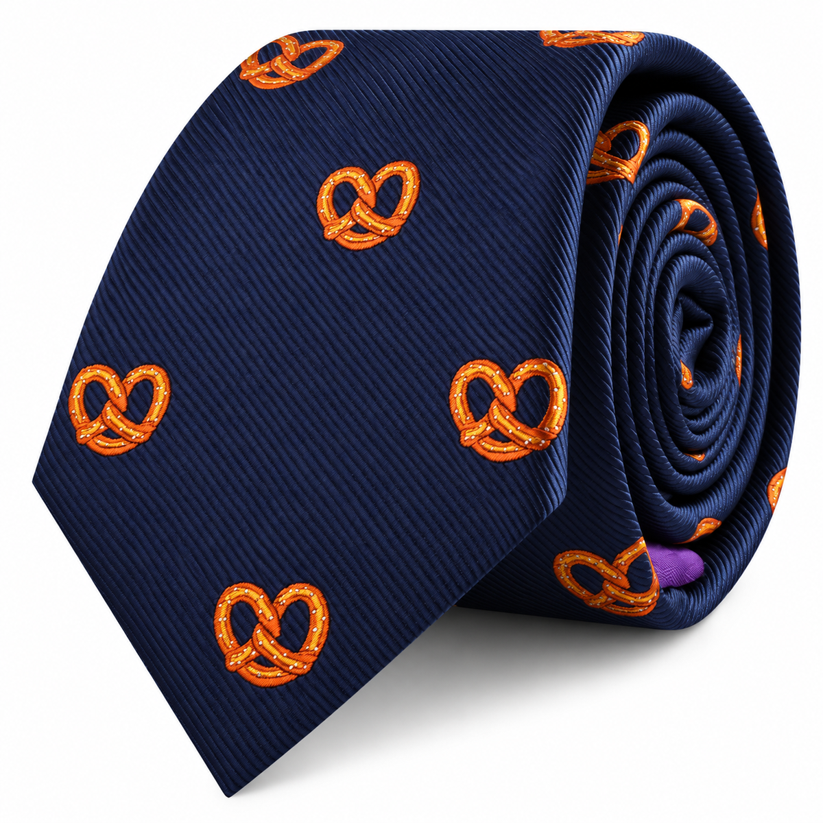 Introducing the Bagel Skinny Tie—a navy blue necktie featuring an embroidered orange bagel pattern, elegantly rolled and set against a white backdrop. Ideal for food enthusiasts seeking a quirky accessory or anyone with a taste for bagel-inspired designs.