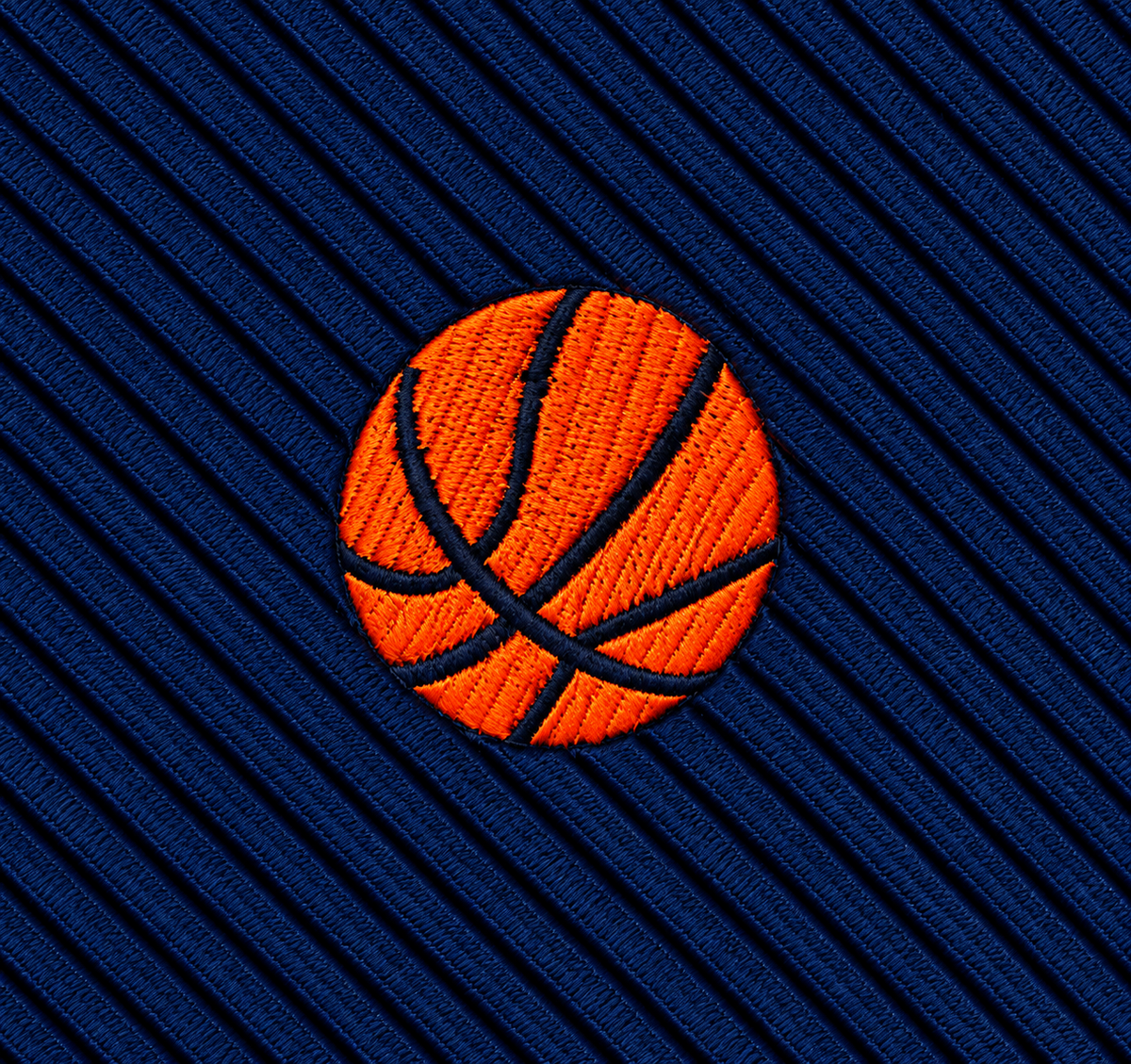 The Basketball Skinny Tie features an embroidered orange basketball on blue, diagonally ribbed fabric, making it a standout accessory—ideal as a unique basketball gift or for adding sporty style to your collection.
