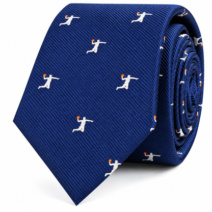 The Basketball Dunk Skinny Tie features a vibrant blue design with a repeating pattern of small white figures dunking orange basketballs, shown rolled up on a white background—making it the perfect gift for basketball enthusiasts or anyone looking for a unique slam dunk accessory.