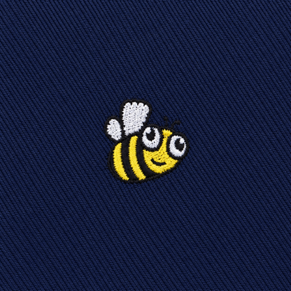 Featuring an embroidered cartoon bee with yellow and black stripes, white wings, and a smiling face on dark blue fabric, the Bee Skinny Tie adds playful character to any wardrobe.