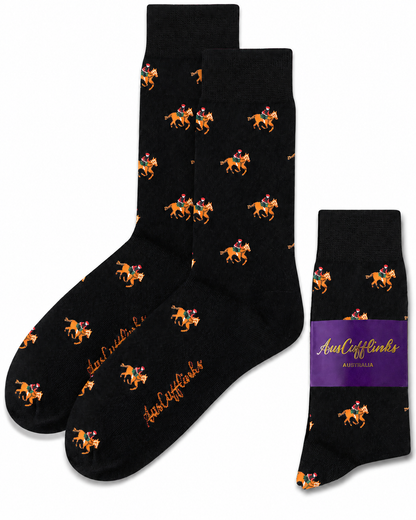 Black Thoroughbred Horse Racing Socks with repeated orange and purple horse rider patterns, shown with a folded pair and a purple AustCufflinks label.