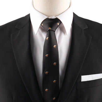 A close-up of a person wearing a black suit, white shirt, Horse Racing Skinny BLACK Tie with small pattern, and a white pocket square.