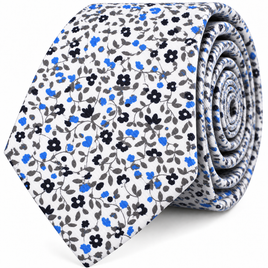Elevate your look with the Black Light Blue Floral Skinny Cotton Tie—a refined men’s accessory featuring a white background adorned with a delicate pattern of small blue, black, and gray flowers and leaves. This rolled-up skinny tie adds a stylish touch to any ensemble.