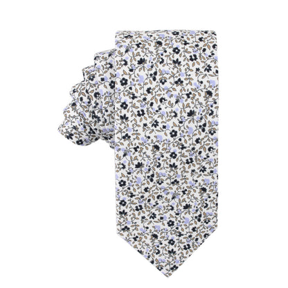 A Black Print Floral Cotton Skinny Tie & Pocket Square Set with a sleek design, showcasing a small floral pattern featuring blue, brown, and black flowers and leaves.