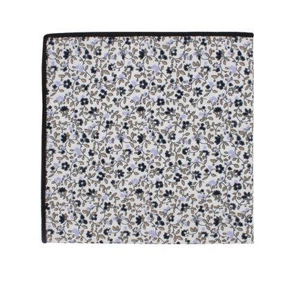A square cloth napkin with a sleek design, showcasing a subtle floral pattern of small black and light purple flowers, scattered across a white background. The edges are neatly finished with a black border can be found in the Black Print Floral Cotton Skinny Tie & Pocket Square Set.