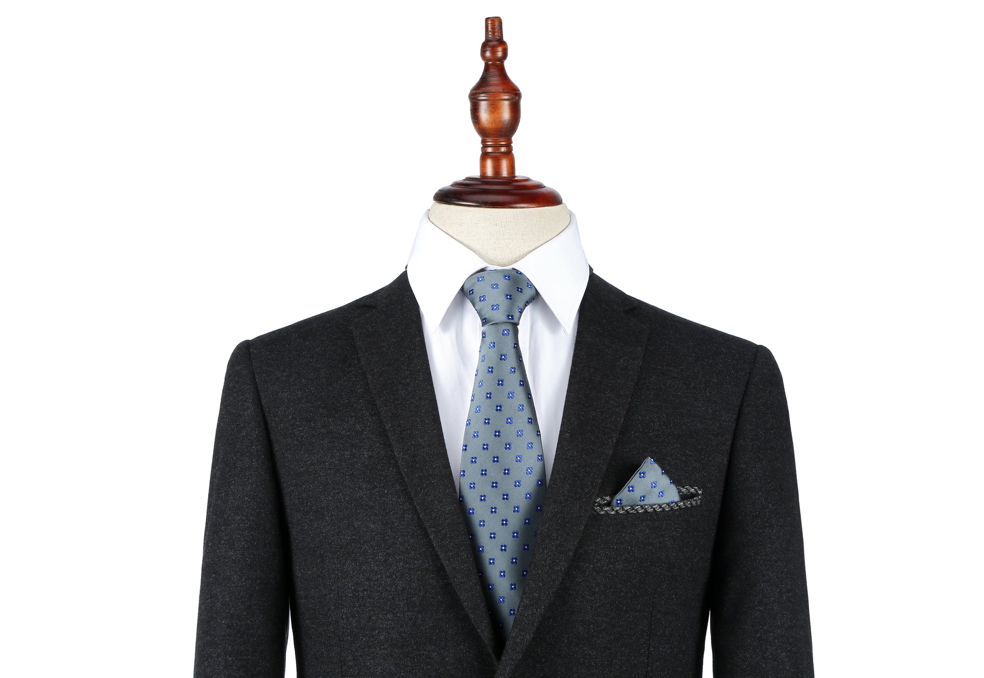 A mannequin dressed in a dark suit, white shirt, and a Blue Flower Grey Business Tie & Pocket Square Set.