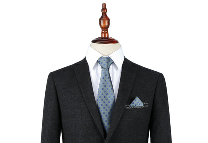 A mannequin dressed in a dark suit, white shirt, and a Blue Flower Grey Business Tie & Pocket Square Set.