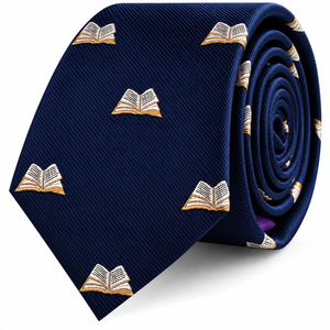The Book Skinny Tie, a rolled-up navy blue necktie featuring a repeated embroidered open book pattern, is the perfect literary gift for avid readers.