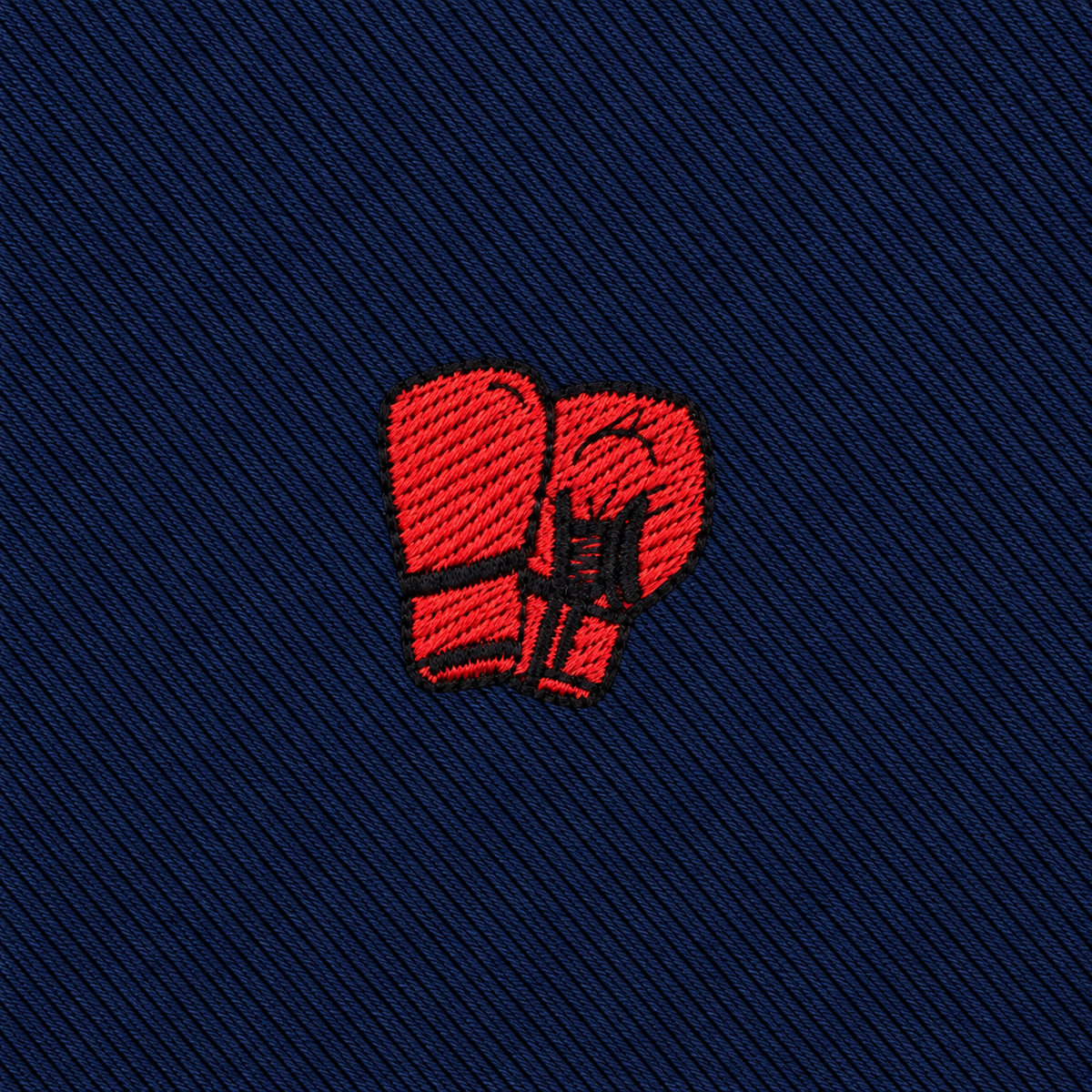 Boxing gloves in red, embroidered on dark blue fabric and shown from above with overlapping gloves—an ideal detail for the Boxing Skinny Tie, making it a unique boxing-themed accessory and a perfect gift for fans of the sport.