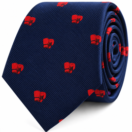 Introducing the Boxing Skinny Tie in navy blue, featuring a playful pattern of small red boxing gloves. Shown rolled up with the tip facing forward, this stylish accessory makes an ideal gift for any boxing fan.