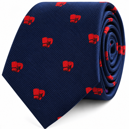 Introducing the Boxing Skinny Tie in navy blue, featuring a playful pattern of small red boxing gloves. Shown rolled up with the tip facing forward, this stylish accessory makes an ideal gift for any boxing fan.