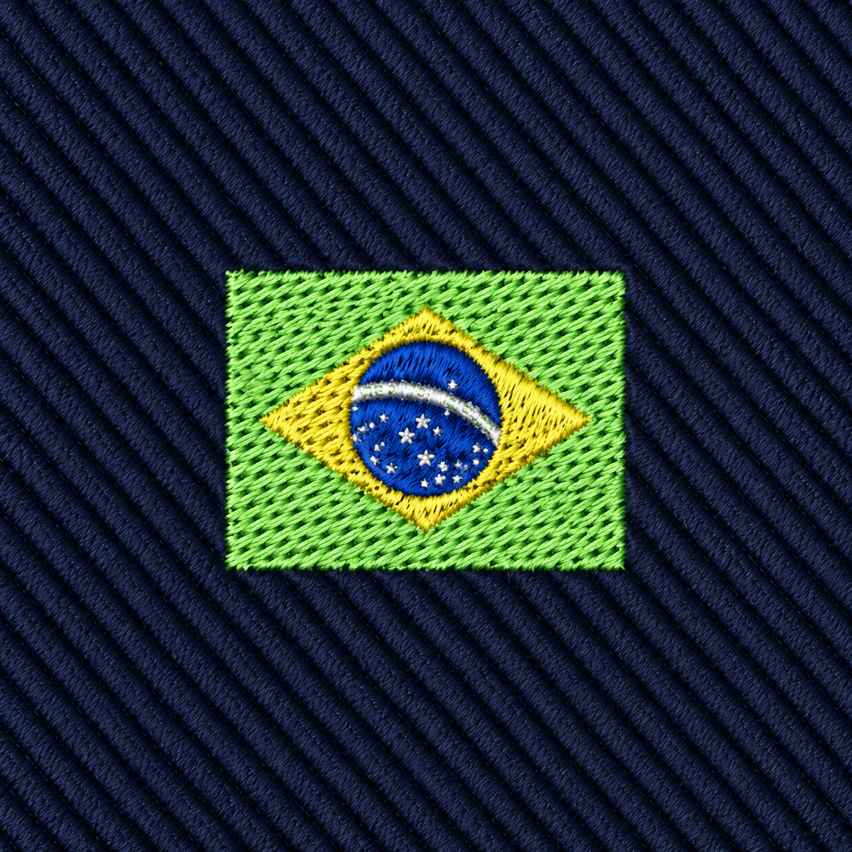 Embroidered patch of the Brazil flag on dark blue diagonal fabric background, featuring green, yellow, blue, and white thread details—perfect for adding a touch of Brazilian pride to the Brazil Flag Skinny Tie.