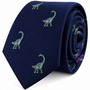 Brontosaurus Skinny Tie—a navy blue necktie adorned with small green brontosaurus patterns throughout the fabric, offering a playful novelty design that adds charm and personality to your attire.