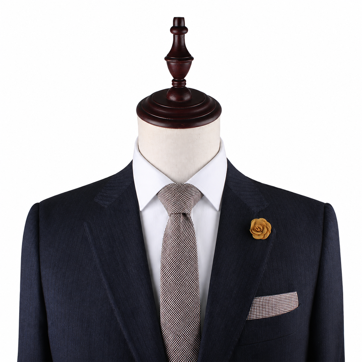 A mannequin showcases the Brown Mini Houndstooth Pocket Square, styled with a dark suit, white shirt, patterned tie, and yellow flower lapel pin—ideal for highlighting sophisticated wedding accessories—against a plain white background.
