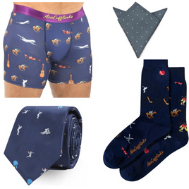 The Swimming Bundle is a men's accessory set with boxers, a pocket square, tie, and socks featuring sports and musical instrument designs on navy backgrounds.