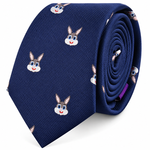 The Bunny Skinny Tie is a rolled blue novelty skinny tie decorated with a repeating pattern of cartoon rabbit faces, complete with big eyes, pink ears, and cheerful smiles. This playful accessory adds a fun animal print element to your outfit.