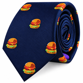Introducing the Burger Skinny Tie: a navy blue skinny tie adorned with a playful, repeating pattern of embroidered cheeseburgers stacked with lettuce, tomato, and cheese—an ideal foodie gift for anyone who enjoys adding a fun twist to classic style.