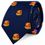 Introducing the Burger Skinny Tie: a navy blue skinny tie adorned with a playful, repeating pattern of embroidered cheeseburgers stacked with lettuce, tomato, and cheese—an ideal foodie gift for anyone who enjoys adding a fun twist to classic style.