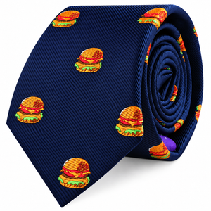 Introducing the Burger Skinny Tie: a navy blue skinny tie adorned with a playful, repeating pattern of embroidered cheeseburgers stacked with lettuce, tomato, and cheese—an ideal foodie gift for anyone who enjoys adding a fun twist to classic style.