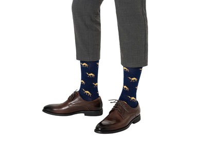 Person wearing gray checkered pants, brown dress shoes, and Camel Socks—an ideal gift for animal lovers—stands against a white background.